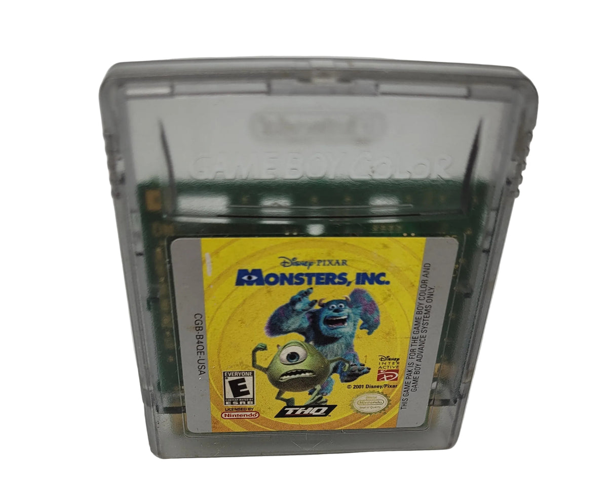 A Disney Pixar Monsters, Inc. THQ Game Boy game cartridge in a translucent gray plastic case, standing upright on a white surface.